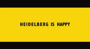 gelber Hintergrund mit schwarzer Schrift: Heidelberg is Happy